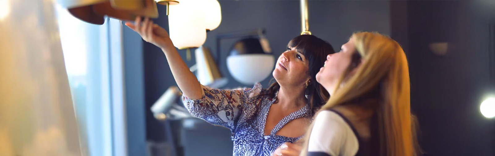 two women looking at chandelier
